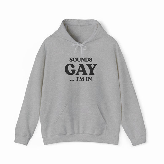 The Sounds Gay I'm In Hoodie is light gray with bold black text on the front. Made from medium-heavy fabric, it includes a front pocket and drawstring hood—ideal for fans of Illegal Shirts.