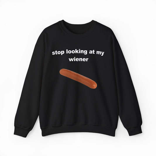The Stop Looking At My Wiener Crewneck is a black sweatshirt featuring white text and a hot dog graphic—ideal for those who enjoy bold, humorous shirts.