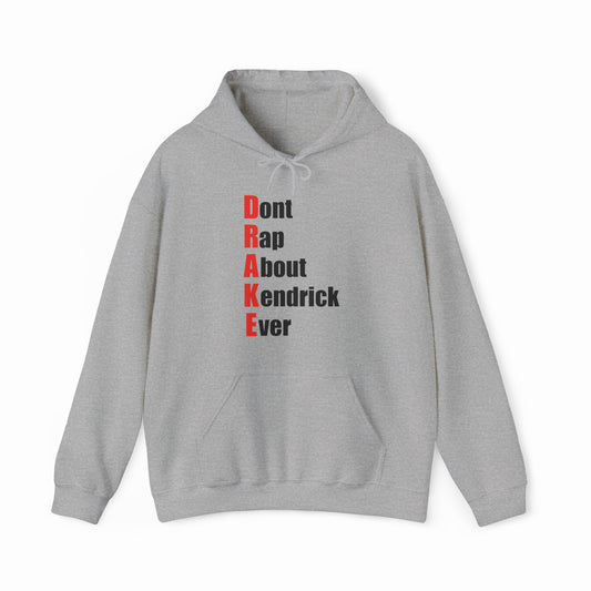 The Drake (Don't Rap About Kendrick Ever) Hoodie is a gray hoodie featuring "Dont Rap About Kendrick Ever" printed vertically in black, with red initials spelling DRAKE down the left—a bold and playful statement piece.