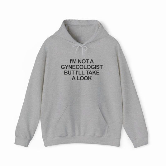 The I'm Not a Gynecologist but I'll Take a Look Hoodie is a light gray hooded sweatshirt with a front pocket and drawstring, perfect for fans of funny T-shirts and the classic humorous "I’m Not a Gynecologist" style.