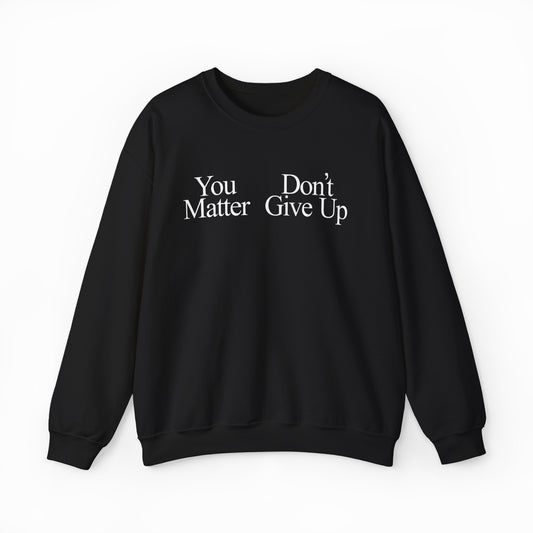 A black You Don't Matter Give Up Crewneck sweatshirt with medium-heavy fabric and white serif text. Displayed flat on a white background; ideal for those who appreciate bold shirts.