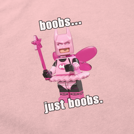 A pink LEGO Batman minifigure dressed as a fairy with wings and a wand is featured on the light pink "Boobs... Just Boobs. T-Shirt," making it a funny, quirky statement shirt for fans of playful style.