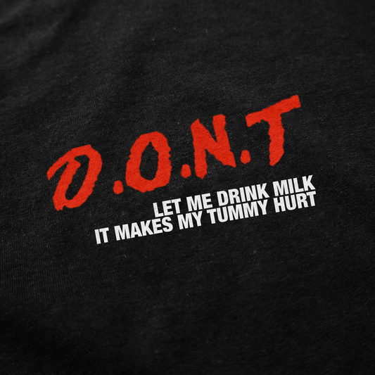 The DONT Let Me Drink Milk T-Shirt features black fabric with bold red “D.O.N.T” and white “LET ME DRINK MILK IT MAKES MY TUMMY HURT.” A funny shirt that stands out and is perfect for fans of humorous tees.