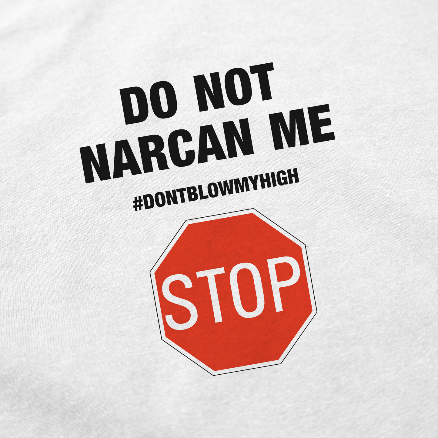 Close-up of the Do Not Narcan Me T-Shirt, made from 100% cotton. Features "DO NOT NARCAN ME #DONTBLOWMYHIGH" above a red stop sign graphic with "STOP" in white letters.