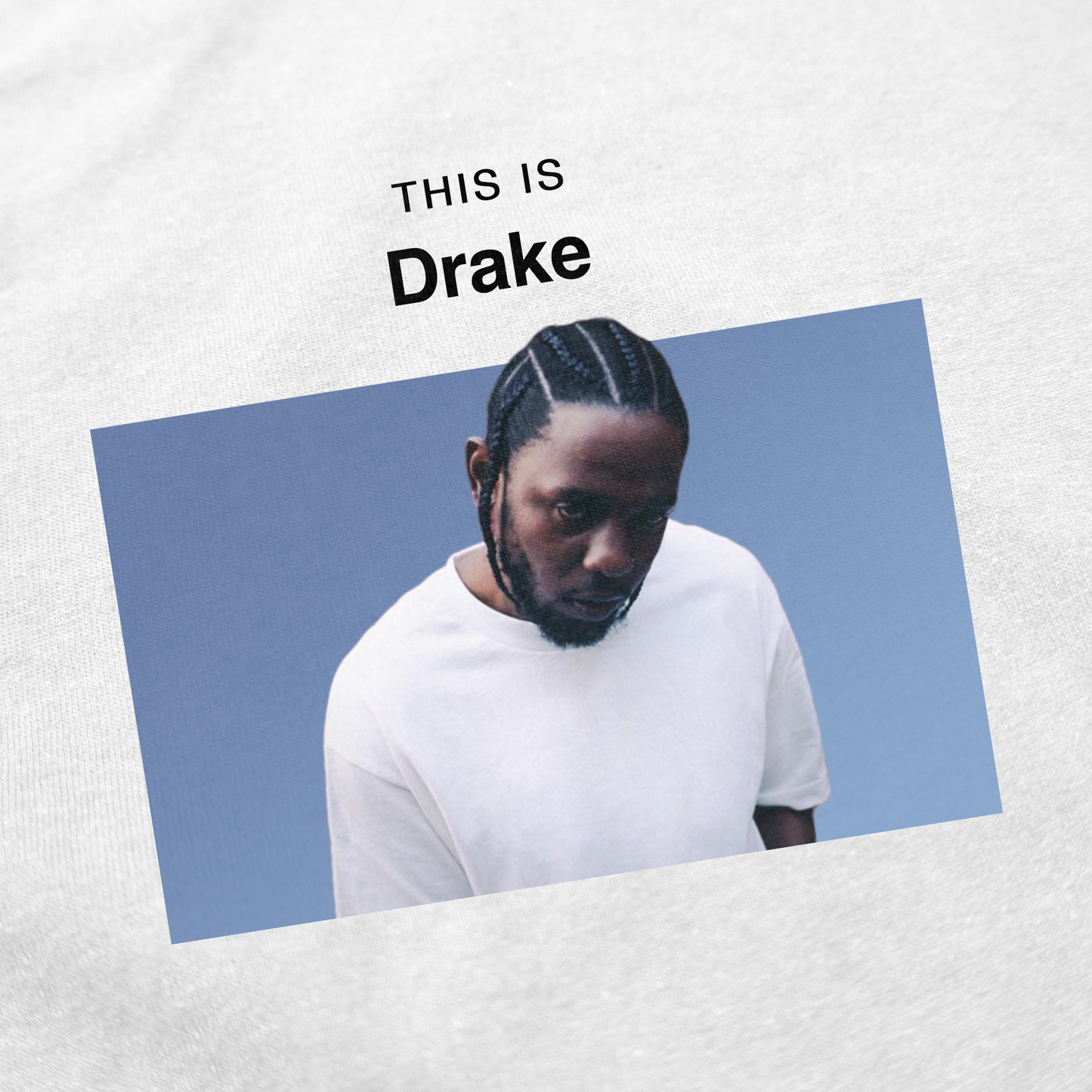 The This Is Drake T-Shirt features a printed image of a man with braided hair in a white t-shirt against a blue background, with "THIS IS Drake" above. Perfect for fans who enjoy unique and funny shirts.