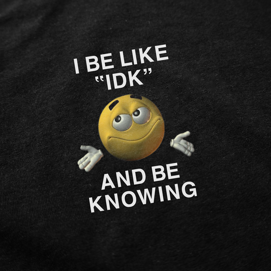 The "I Be Like 'IDK' And Be Knowing" T-Shirt features a shrugging yellow emoji with raised eyebrows and hands up, plus the catchy phrase on black—a fun, conversation-starting shirt.