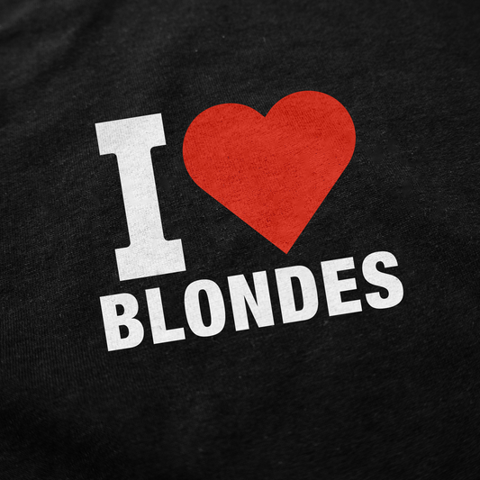 Close-up of the I Heart Blondes T-Shirt by Illegal Shirts, made from 100% combed ring-spun cotton, featuring bold white text and a red heart on a black background.
