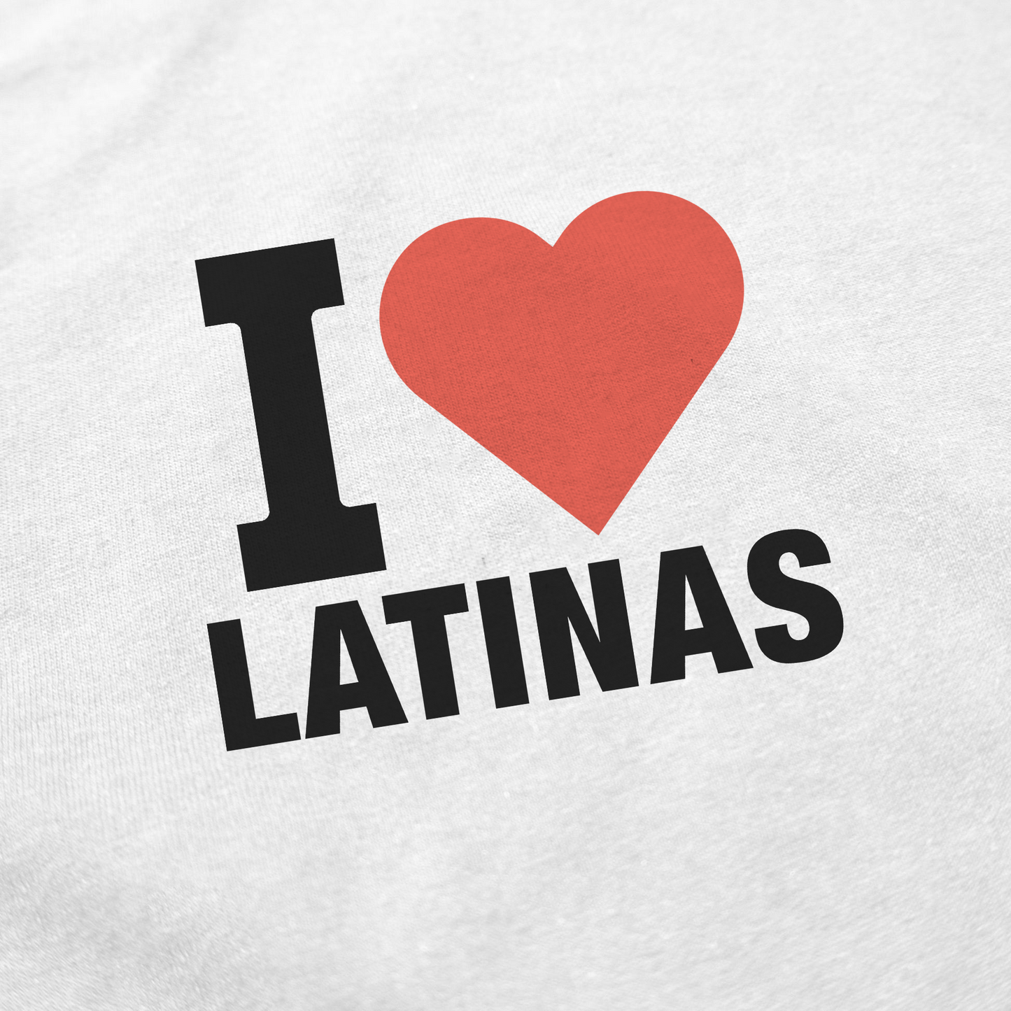 The image shows the I Heart Latinas T-Shirt, featuring “I ♥ LATINAS” printed on white fabric made from ethically grown cotton for a bold statement.