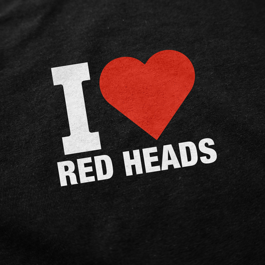 The image shows text on quality cotton fabric reading "I ♥ RED HEADS" with a red heart—ideal for fans of funny shirts like the I Heart Red Heads T-Shirt.