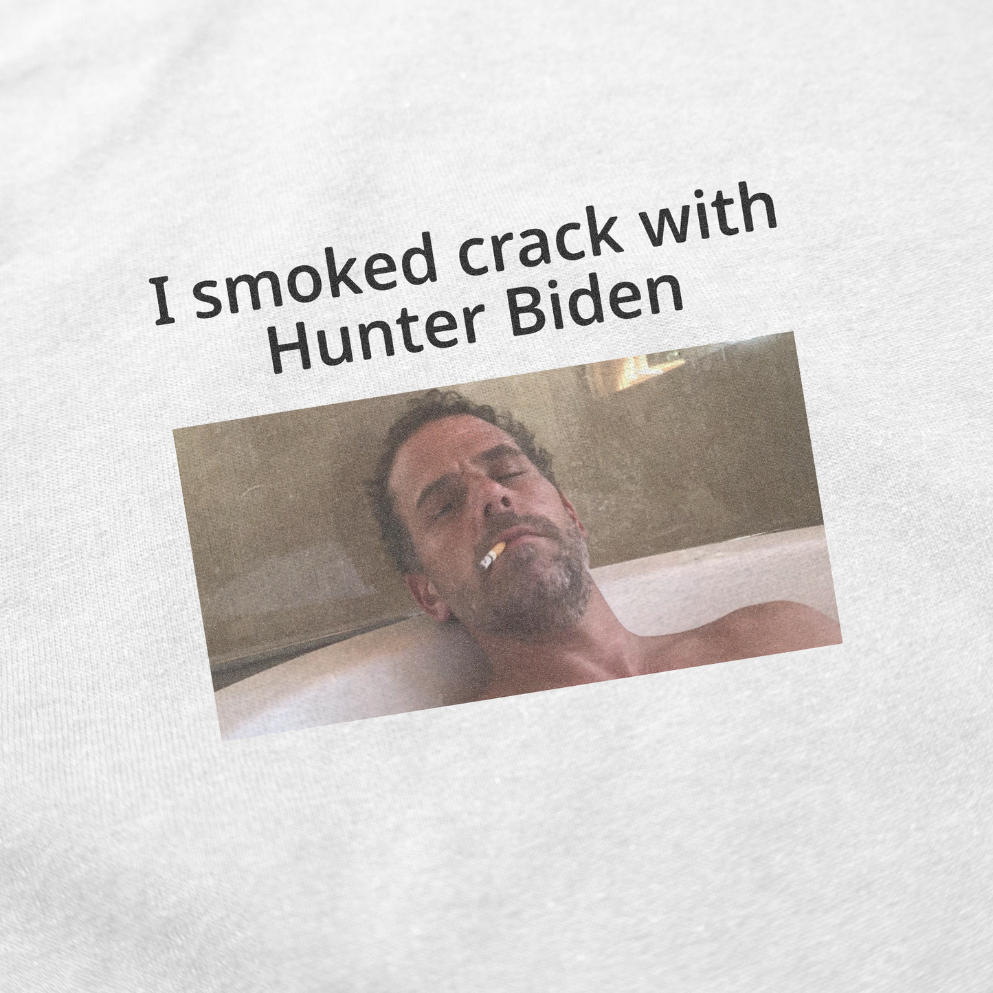 A man wearing an "I Smoked Crack With Hunter Biden T-Shirt" stands smoking a cigarette.