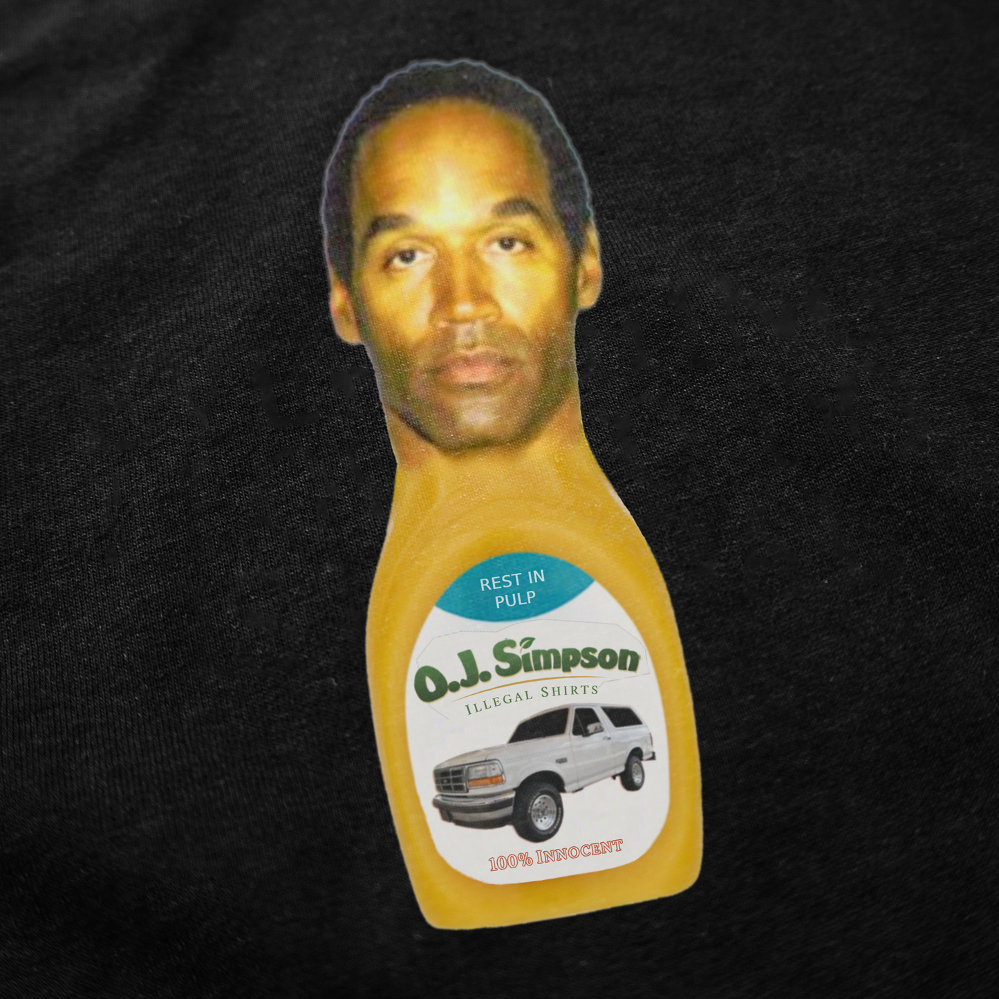 The O.J. Simpson T-Shirt showcases a graphic with a juice bottle featuring his face, a white SUV, and "Rest in Pulp" on the label. Made from 100% cotton, it’s a unique and comfortable addition to any collection.