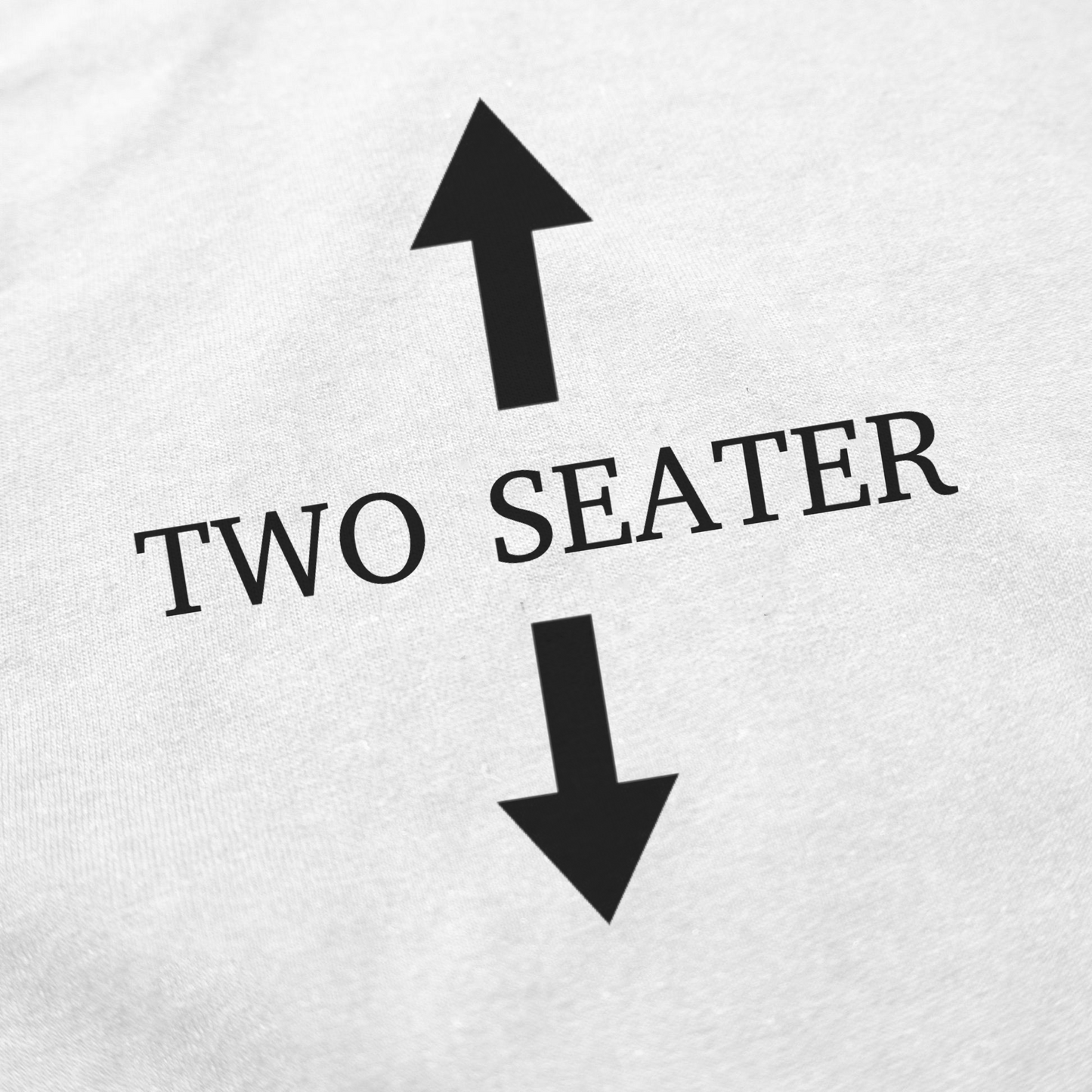 The Two Seater T-Shirt features “TWO SEATER” in black between two large black arrows on a white, 175 GSM ethically grown cotton surface.