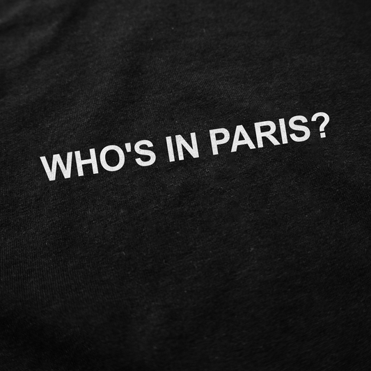 The Who's in Paris? T-Shirt features bold white capital letters on black fabric, adding a humorous touch to your collection of funny shirts.