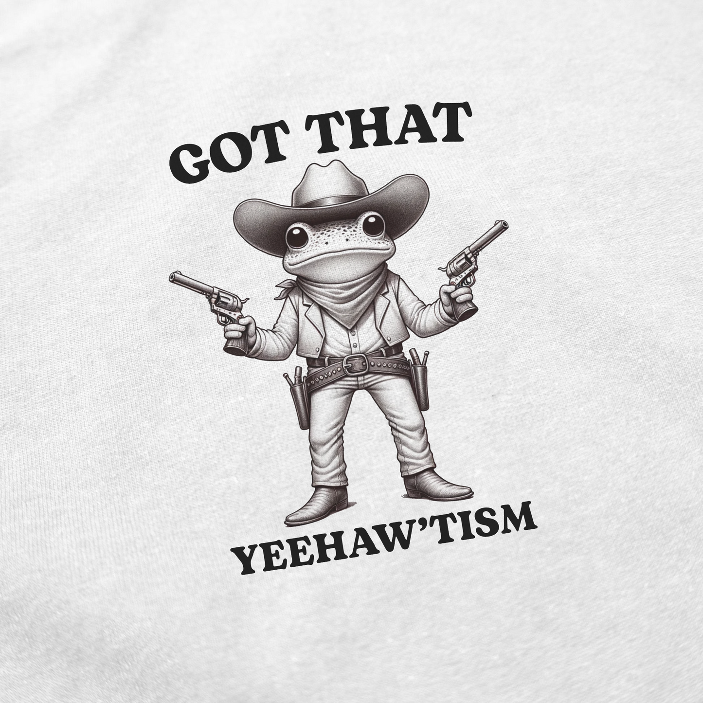 The Got That Yeehaw'Tism T-Shirt features a cartoon cowboy frog with pistols and the phrase “GOT THAT YEEHAW’TISM”—a funny tee perfect for fans of clever designs and humorous shirts.