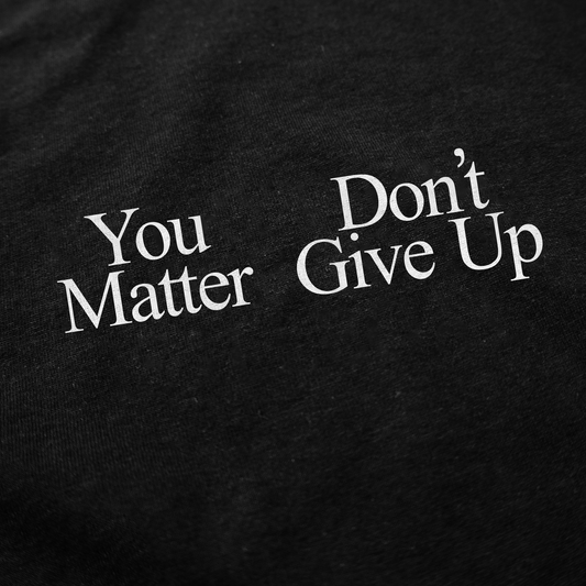White text on black reads "You Don't Matter Give Up" in bold, serif font—a striking design for the You Don't Matter Give Up T-Shirt that sets it apart from typical funny or Illegal Shirts styles.