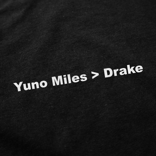 The Yuno Miles > Drake T-Shirt is a black tee with a bold white slogan, perfect for fans who love funny shirts and playful style.