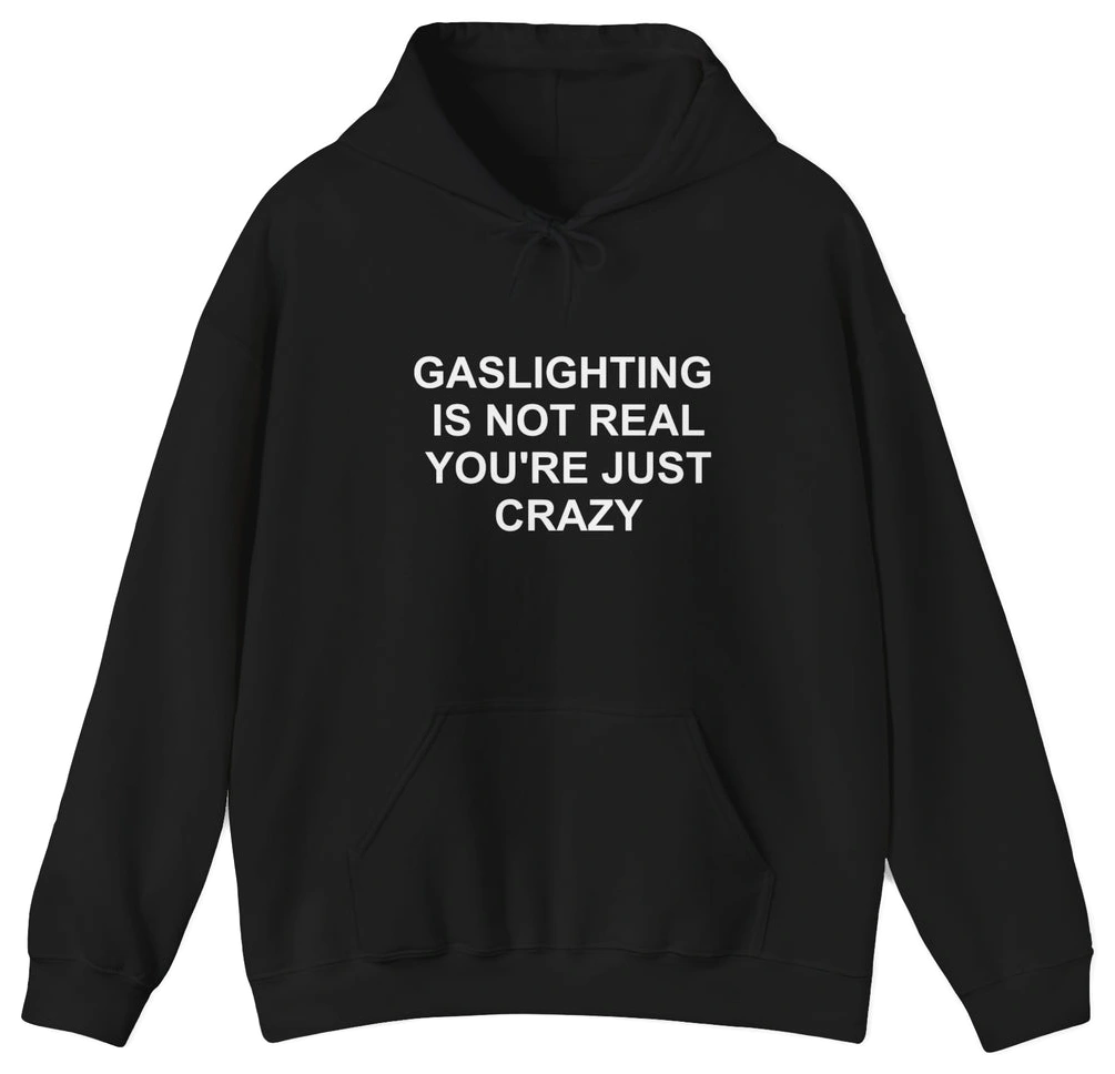 The Gaslighting Is Not Real You're Just Crazy Hoodie is a black cotton-polyester sweatshirt with "GASLIGHTING IS NOT REAL YOURE JUST CRAZY" printed in white—perfect for fans of edgy Illegal Shirts designs.