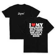 Two black I Heart My Girlfriend So Please Stay Away She Has A Nuclear Bomb T-Shirts (Backprint), made from 175 GSM ethically grown cotton; “Illegal” in white script on the front, bold back text: I ♥ MY GIRLFRIEND SO PLEASE STAY AWAY SHE HAS A NUCLEAR BOMB.