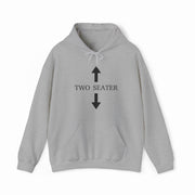 The Two Seater Hoodie is light gray, made from medium-heavy fabric, with "TWO SEATER" in black on the chest, flanked by a black upward arrow above and a black downward arrow below.