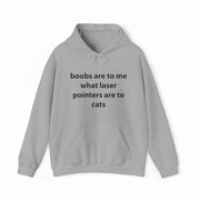 The Boobs Are To Me What Laser Pointers Are To Cats Hoodie from Illegal Shirts features a bold, cheeky design in light gray—perfect for anyone who loves clever, funny humor.