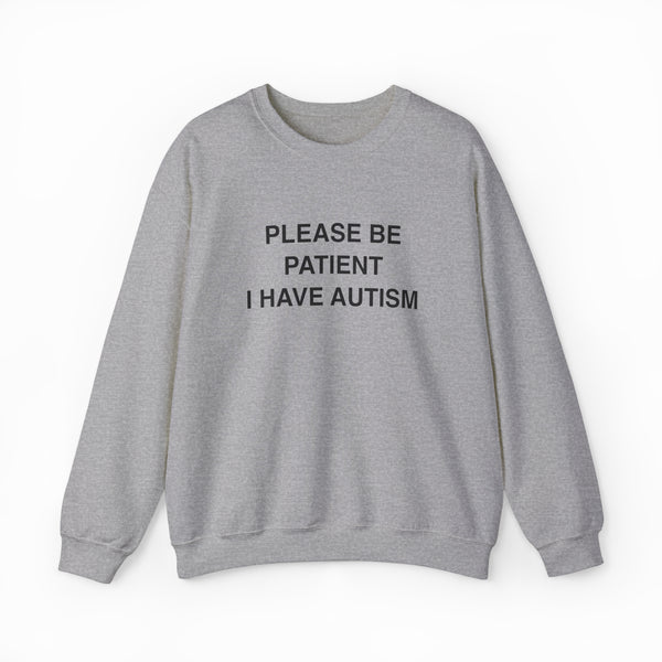 The Please Be Patient I Have Autism Crewneck is a light gray sweatshirt from Illegal Shirts with "PLEASE BE PATIENT I HAVE AUTISM" in bold black letters on the front, shown laid flat on a white background.