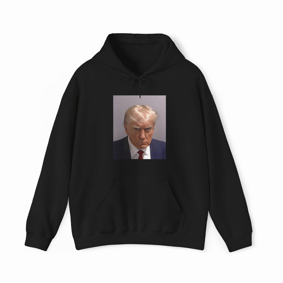 The Trump Mug Shot Hoodie is a black hoodie featuring a printed photo of a blond man in a suit and tie with a serious expression, and includes a tear-away label for added comfort.