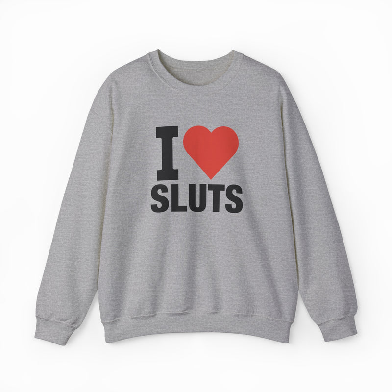 The I Heart Sluts Crewneck from Illegal Shirts is a gray sweatshirt featuring "I Heart Sluts" in bold black text with a red heart on the front, made from cozy medium-heavy fabric.