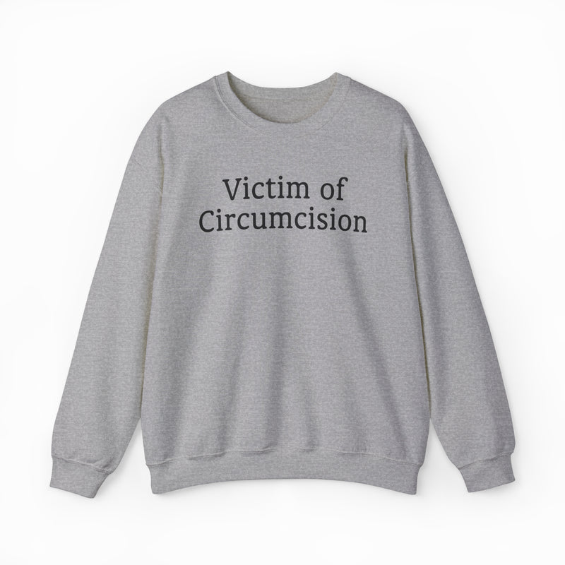 The Victim Of Circumcision Crewneck is a gray sweatshirt from the Illegal Shirts collection, made of medium-heavy fabric and featuring bold black "Victim of Circumcision" text across the front.