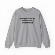 The My Opps Hate Me Because I'm A Sweetheart Crewneck is a light gray sweatshirt with bold black text—ideal for anyone who loves funny statement shirts.