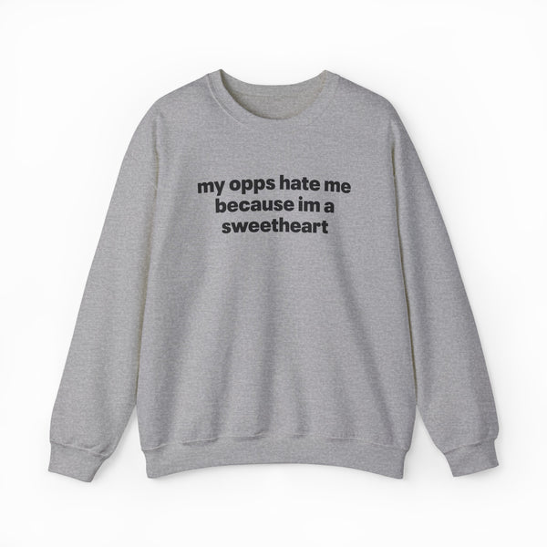 The My Opps Hate Me Because I'm A Sweetheart Crewneck is a light gray sweatshirt with bold black text—ideal for anyone who loves funny statement shirts.