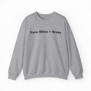 The Yuno Miles > Drake Crewneck is a gray sweatshirt featuring "Yuno Miles > Drake" in bold black text—a perfect pick for fans of funny shirts and the iconic crewneck style.