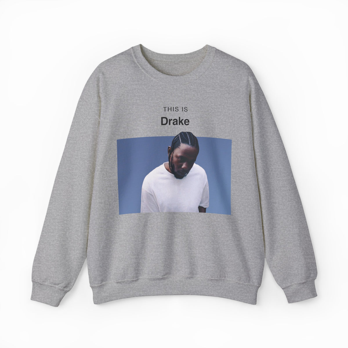 The This Is Drake Crewneck is a gray sweatshirt featuring a photo of a man in a white shirt looking down, with “THIS IS Drake” printed above—a stylish nod to iconic and funny shirts.