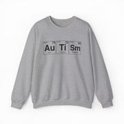 The Autism Periodic Table Crewneck by Illegal Shirts is a gray sweatshirt made from medium-heavy fabric, featuring "Autism" spelled with Au (gold), Ti (titanium), and Sm (samarium) symbols, including atomic numbers and weights.