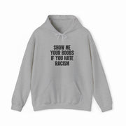The Show Your Boobs If You Hate Racism Hoodie is light gray with a front pocket and drawstring hood, featuring bold black text. Ideal for those who love funny shirts with a strong anti-racism message.