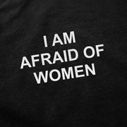 The I Am Afraid Of Women T-Shirt features white, all-caps text centered on black, 175 GSM fabric made from ethically grown cotton.