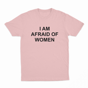 The I Am Afraid Of Women T-Shirt is light pink, made from 175 GSM ethically grown cotton, and features bold black "I AM AFRAID OF WOMEN" text printed in capitals on the front.