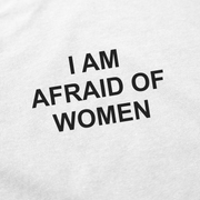 The I Am Afraid Of Women T-Shirt is a white cotton tee made from ethically grown cotton, featuring bold black all-caps text that says "I AM AFRAID OF WOMEN.