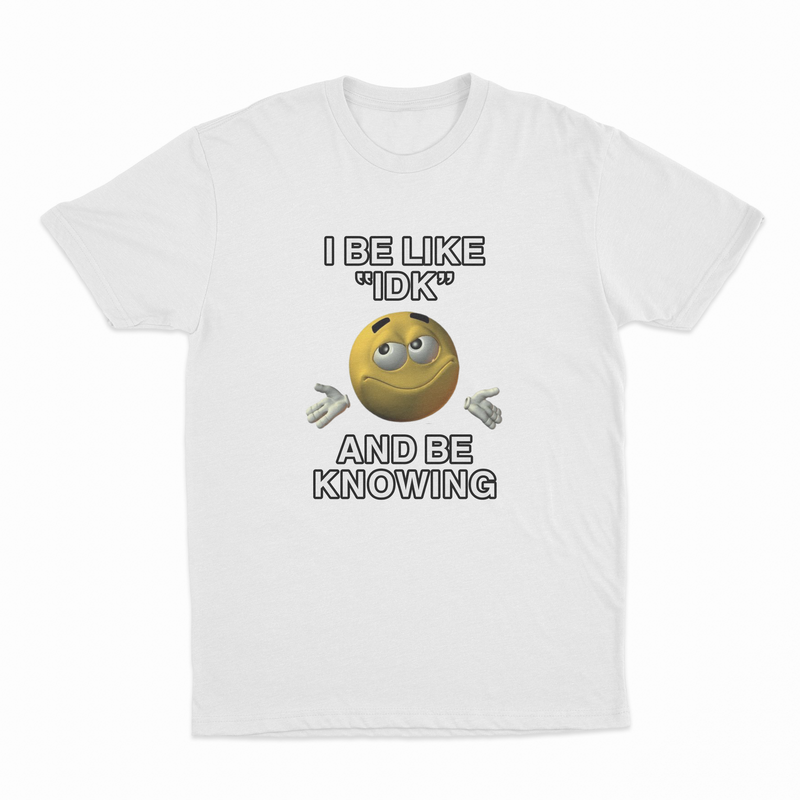 The I Be Like "IDK" And Be Knowing T-Shirt is a white tee featuring a smiling, shrugging emoji with the phrase in bold black letters—a fun choice for anyone who loves witty shirts and conversation starters.