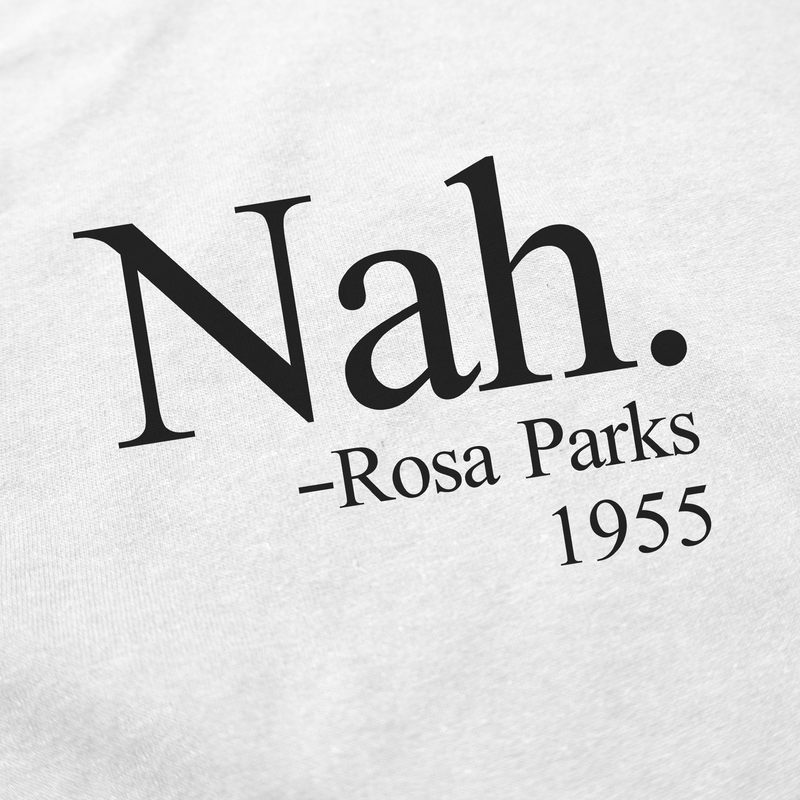 The Nah. T-Shirt features black "Nah. -Rosa Parks 1955" text on white fabric, honoring Rosa Parks' 1955 stand. Made from ethically grown cotton, it offers a comfortable and conscious choice.