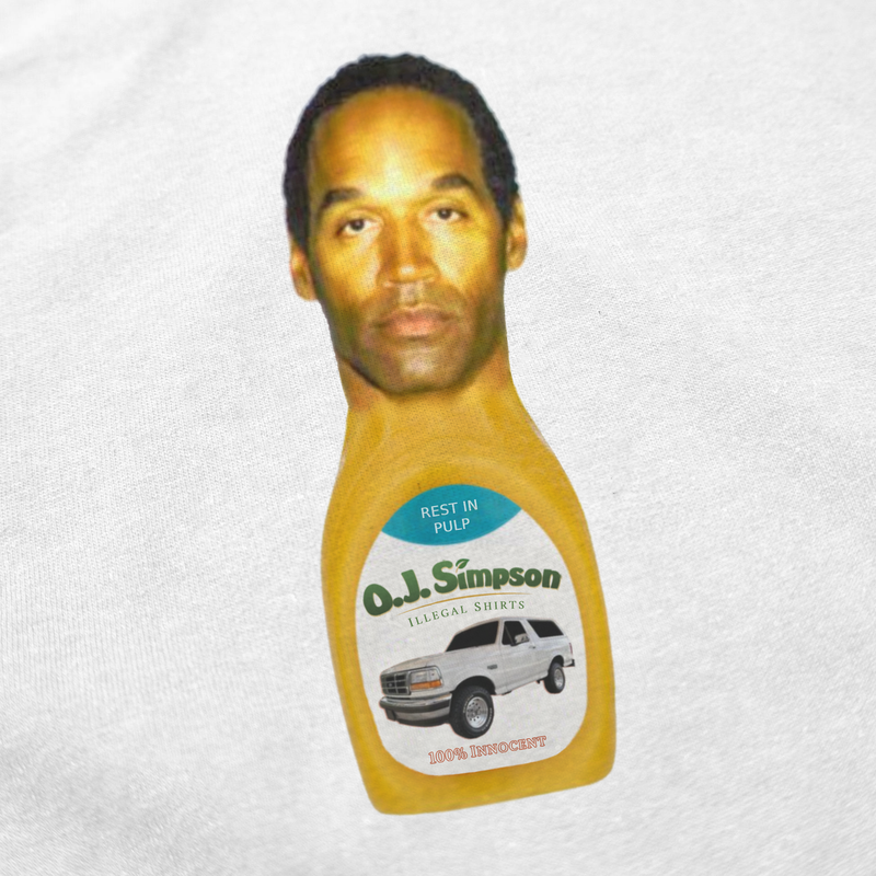 The O.J. Simpson T-Shirt features a digitally edited image of his face on a juice bottle with a white SUV and phrases like "Rest in Pulp," "Illegal Shirts," and "100% Innocent." Made ethically from 100% cotton.
