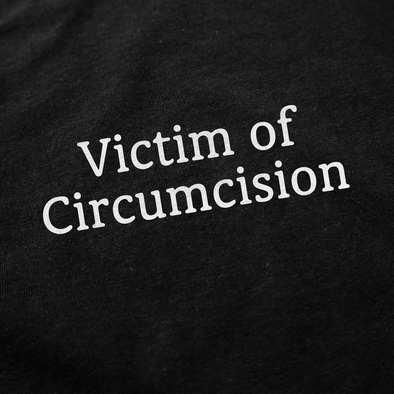 White text on a black fabric reads, "Victim of Circumcision." The Victim Of Circumcision T-Shirt is a humorous conversation starter.