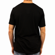 Wearing the I Heart Latinas T-Shirt, a person stands with their back to the camera in light blue jeans against a white background.