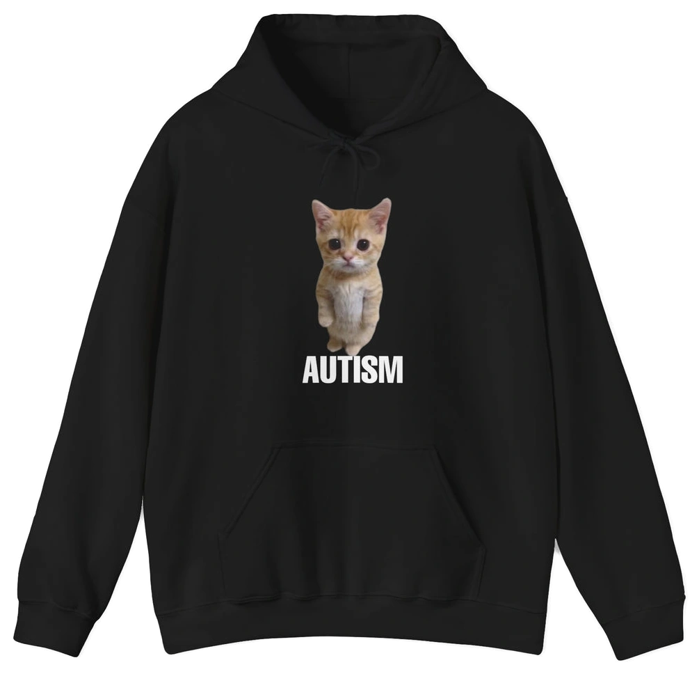 The Autism Cat Hoodie is black, made from medium-heavy fabric for comfort, and features a photo of a small orange kitten above "AUTISM" in bold white letters—a cozy, heartfelt design.