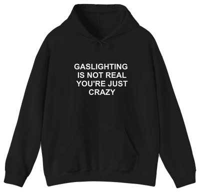 The Gaslighting Is Not Real You're Just Crazy Hoodie is a black cotton-polyester sweatshirt with "GASLIGHTING IS NOT REAL YOURE JUST CRAZY" printed in white—perfect for fans of edgy Illegal Shirts designs.