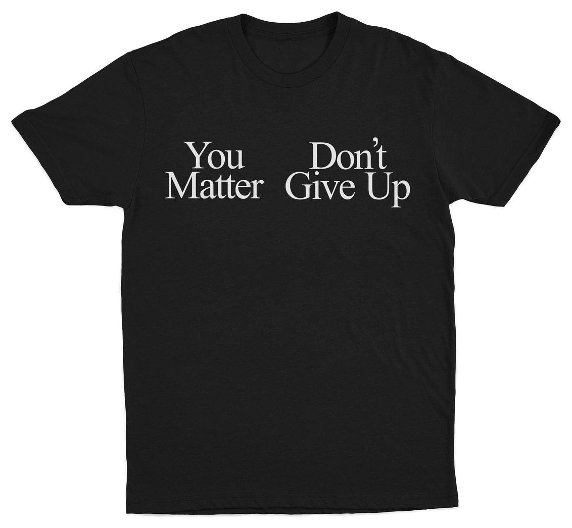 The You Don't Matter Give Up T-Shirt is a black tee with bold white serif text—ideal for fans of Illegal Shirts and statement designs.