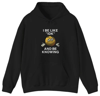 The I Be Like "IDK" And Be Knowing Hoodie is a cotton-polyester black sweatshirt with "I BE LIKE IDK AND BE KNOWING" text and a brown smiling shrugging emoji—perfect for fans of the viral IDK shirt style.