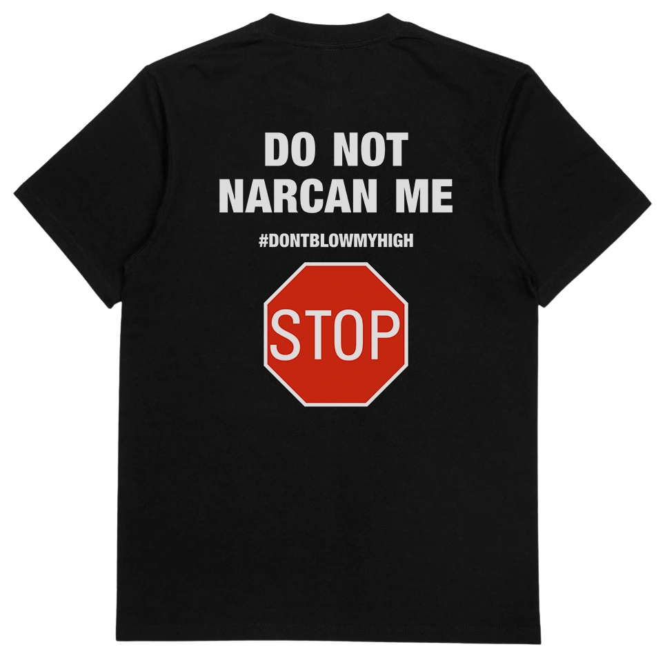 The Do Not Narcan Me T-Shirt (Backprint) is a black, 175 GSM tee made from ethically grown cotton. The back features white text—DO NOT NARCAN ME and #DONTBLOWMYHIGH—above a red stop sign graphic with STOP in white letters.