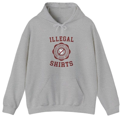The Illegal Shirts Emblem Hoodie is a gray hoodie with a front pocket, bold red “ILLEGAL SHIRTS” text, and a striking red circular emblem—ideal for anyone who loves funny shirts with attitude.