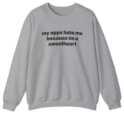 The My Opps Hate Me Because I'm A Sweetheart Crewneck is a light gray sweatshirt with bold black text—ideal for anyone who loves funny statement shirts.
