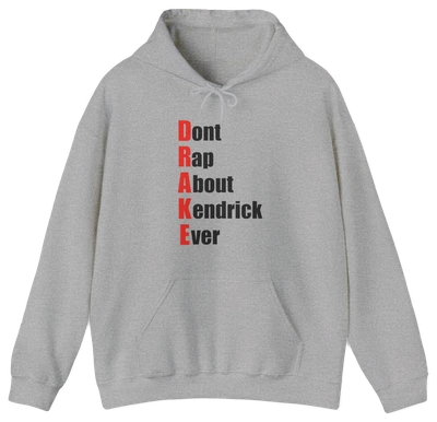 The Drake (Don't Rap About Kendrick Ever) Hoodie is a gray hoodie featuring "Dont Rap About Kendrick Ever" printed vertically in black, with red initials spelling DRAKE down the left—a bold and playful statement piece.